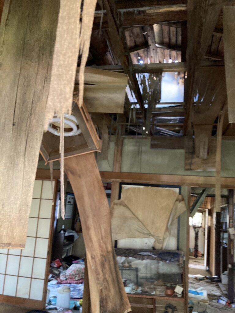 屋根が抜けて青空が見えている空き家写真
